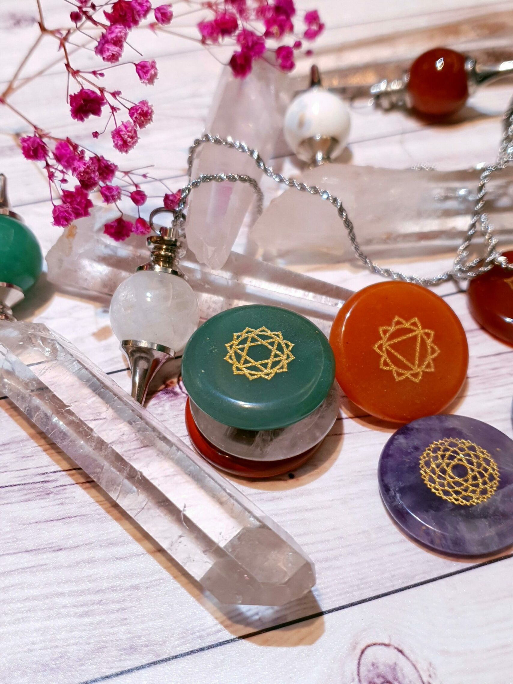 Vibrant arrangement of healing crystals and chakra symbols on a wooden surface.